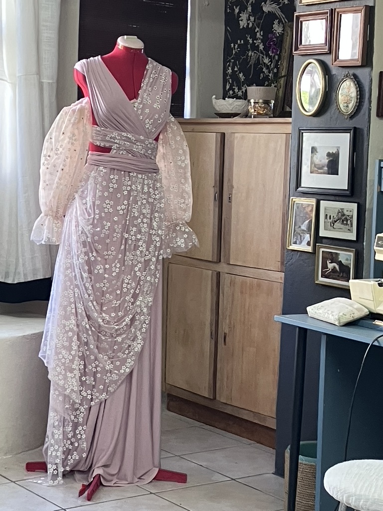 Blush lace gown on a dress form