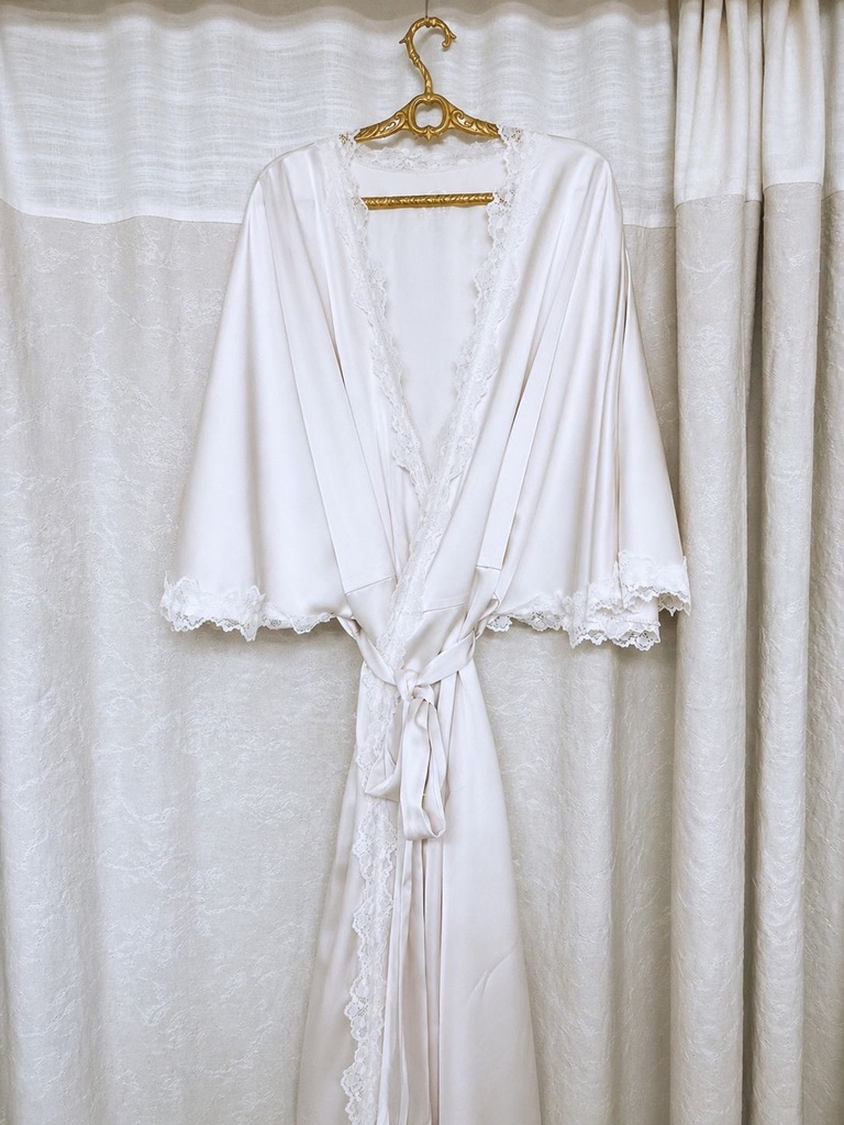 Ivory bridal robe hanging in the studio