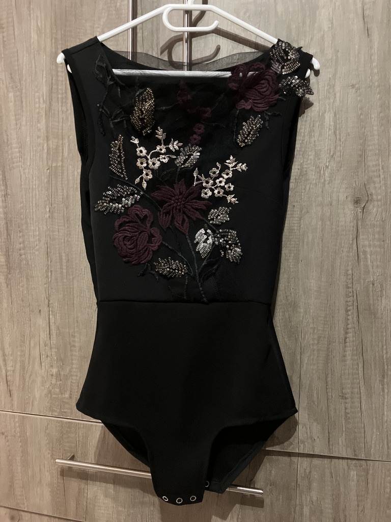 Embroidered black body, laid flat