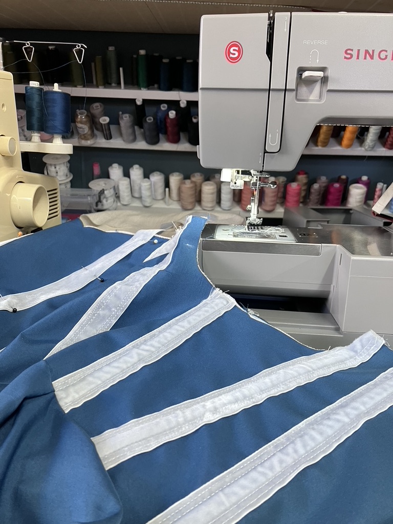 Teal dress in progress at the machine