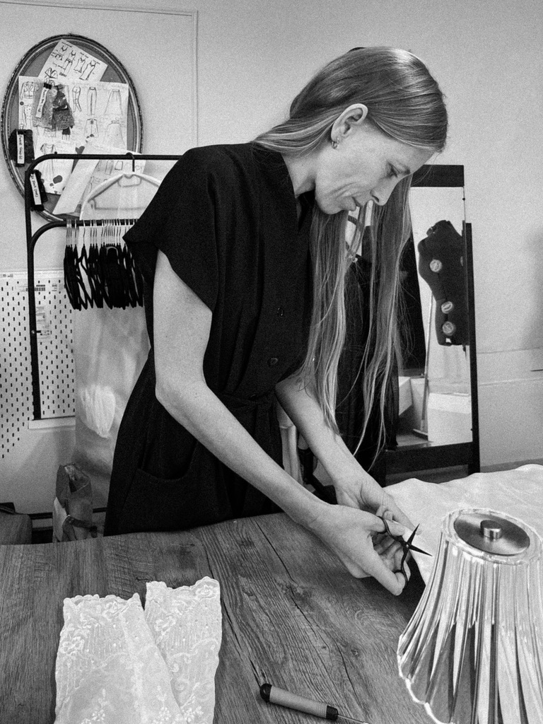 A bodice being pinned by hand